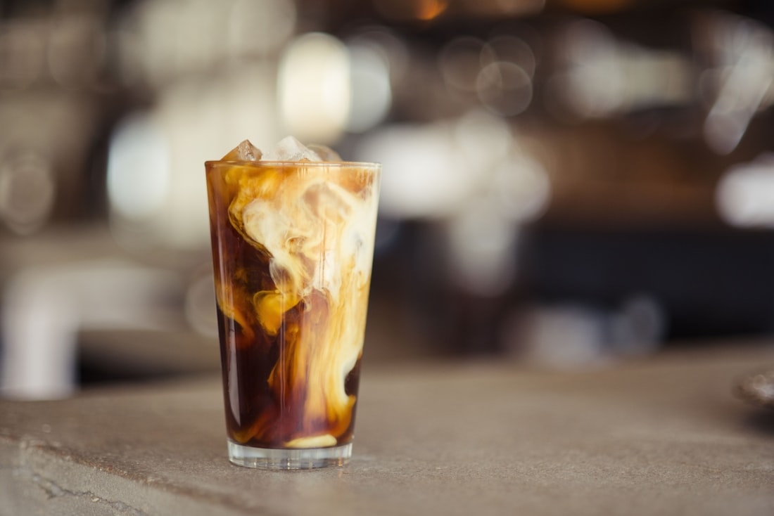 Iced latte with milk swirling